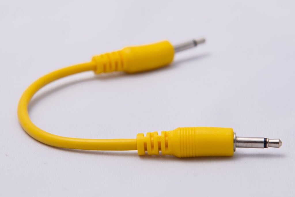 A yellow 3.5mm x 10cm patch cable.